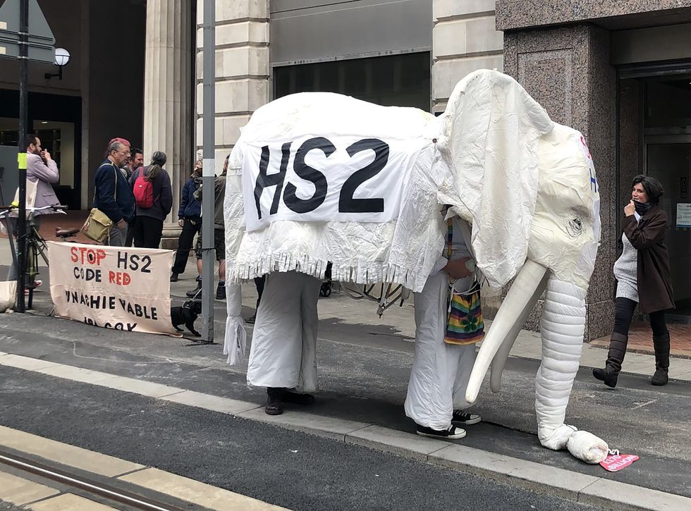 Protestors outside Birmingham Civil Justice Centre, as environmental activists opposed to the HS2 rail link have told a court a route-wide injunction being sought against "persons unknown" could prevent peaceful protest against illegal tree-felling and "wildlife crimes".