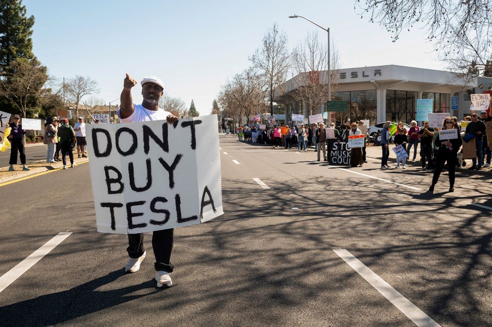 Protests outside a Tesla dealership in Palo Alto, California