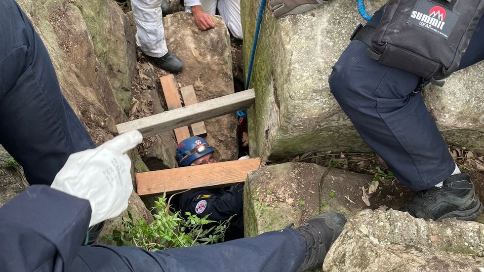 Rescue workers trying to free Campbell from the rock