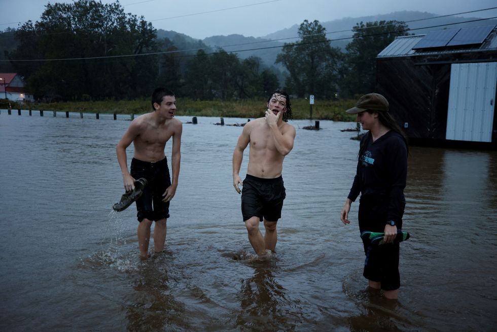 Residents play in flood waters as Hurricane Helene approaches in the North Carolina mountains, in Valle Crucis, North Carolina\u200b