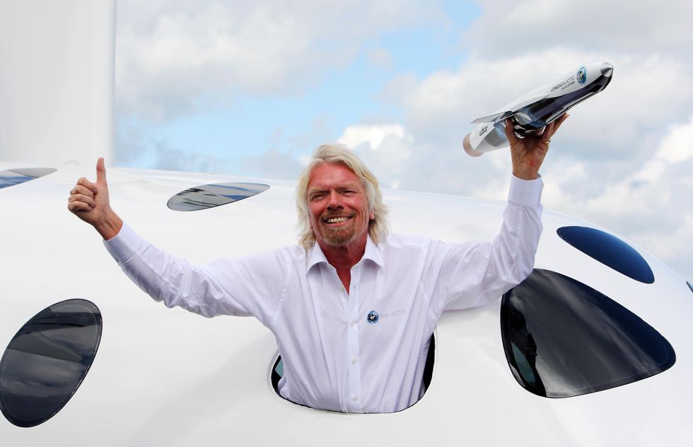 Richard Branson posing on his Virgin Galactic