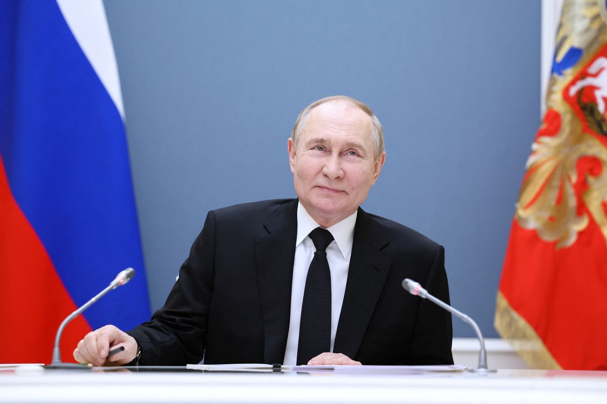 Russian President Vladimir Putin holds a meeting with large families from various Russia's regions via video link at the Kremlin in Moscow