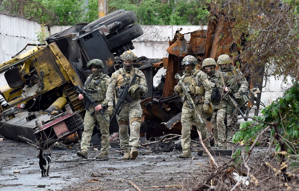 Russian servicemen patrol the destroyed part of the Ilyich Iron and Steel Works in Ukraine's port city of Mariupol