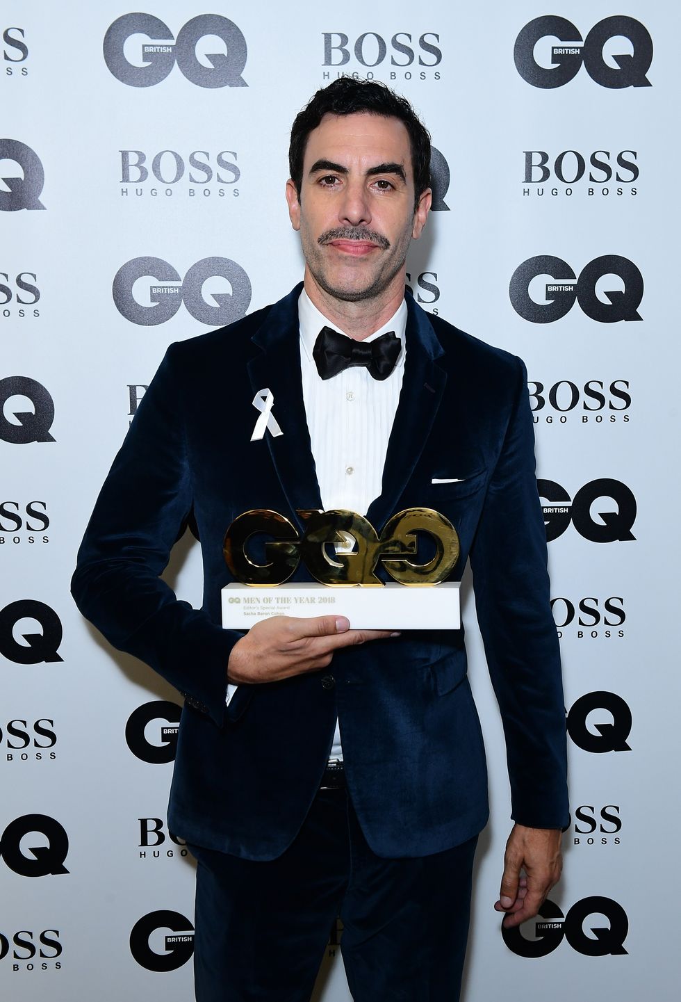 Sacha Baron Cohen in the press room with the Editor's Special Award at the GQ Men of the Year Awards 2018