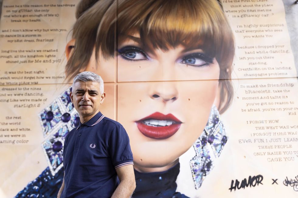 Sadiq Khan in front of Taylor Swift poster