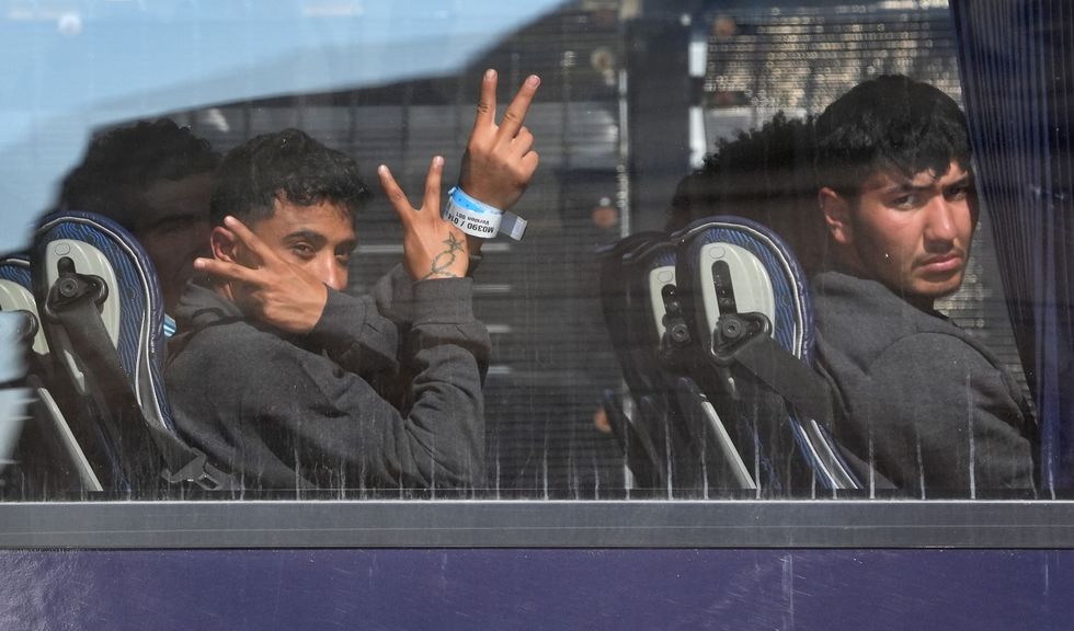 Small boat migrants on bus