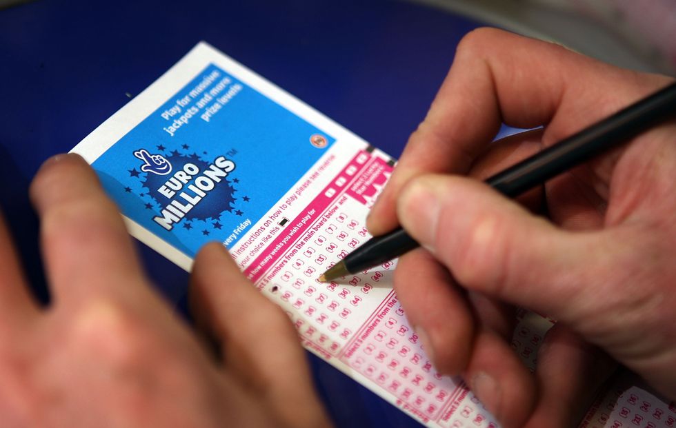 Somebody putting numbers down on a Euromillions ticket