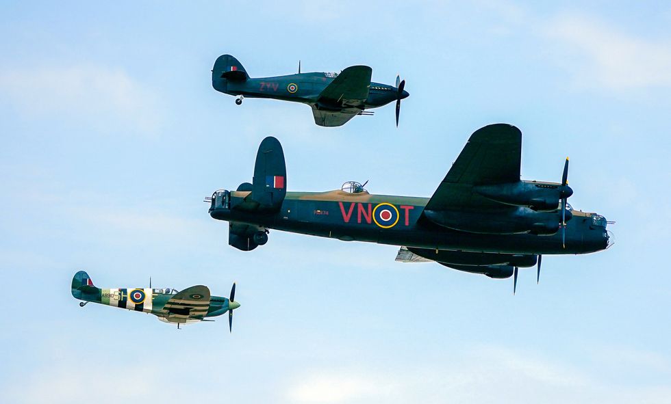 Spitfire, a Hawker Hurricane, and a Lancaster bomber, part of the Battle of Britain Memorial Flight, during the annual Southport Air Show at Southport beach in Merseyside