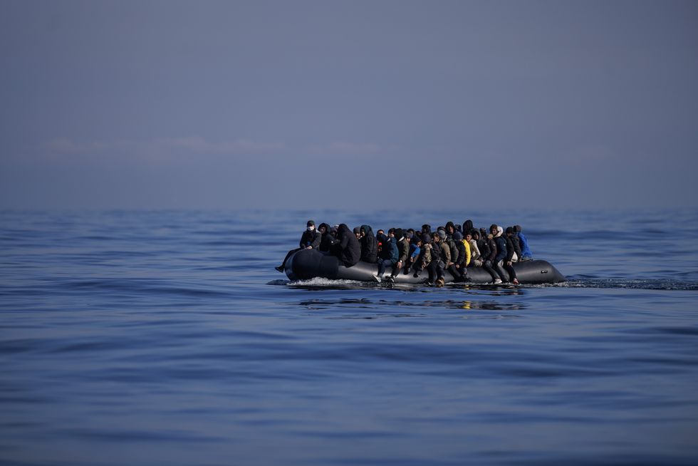 Stock image of migrants aboard a dinghy