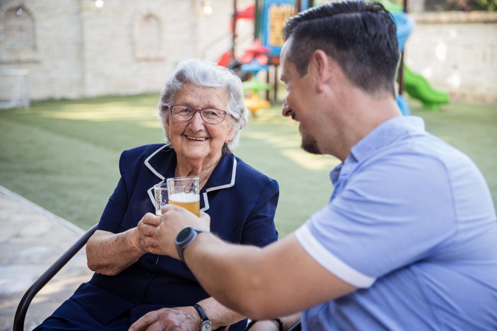 (Stock) Mum and son enjoy a beer in the pub