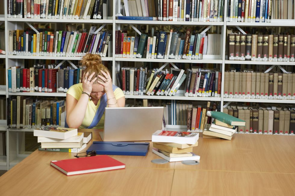 Student with books in library 