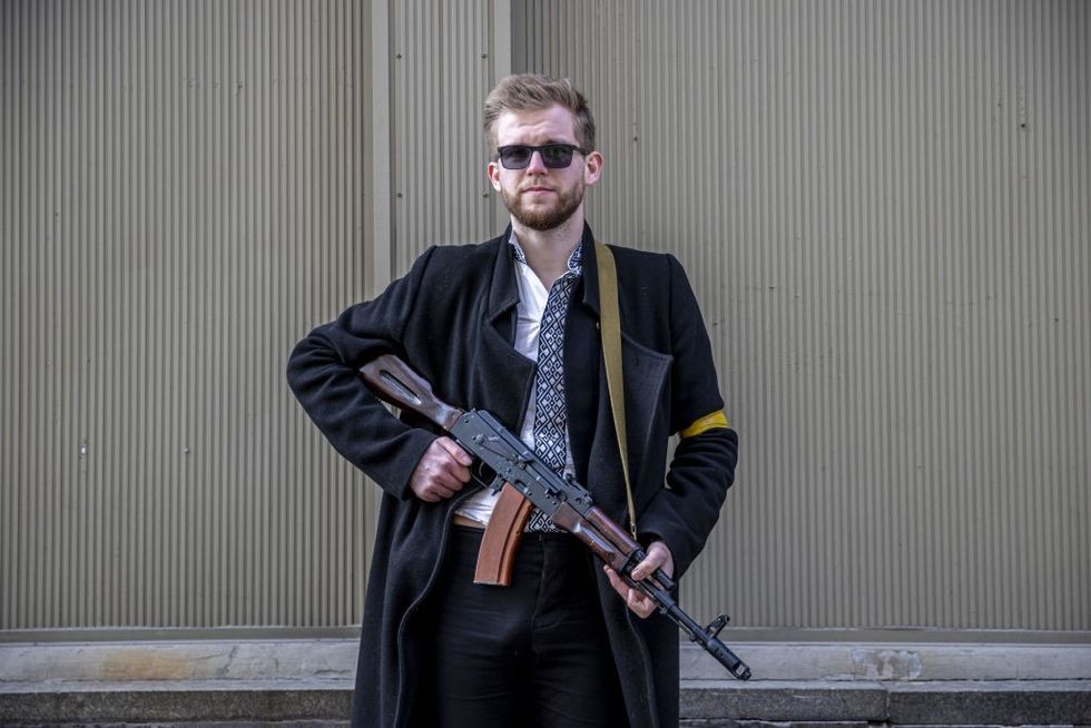 Sviatoslav Yurash is seen at a street with his weapon to defend Kyivu200b