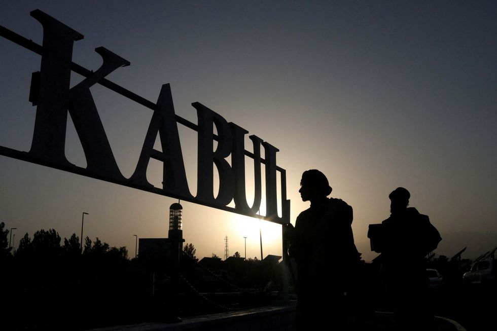 Taliban soldiers stand in front of a sign at the international airport in Kabul, Afghanistan, September 9, 2021\u200b