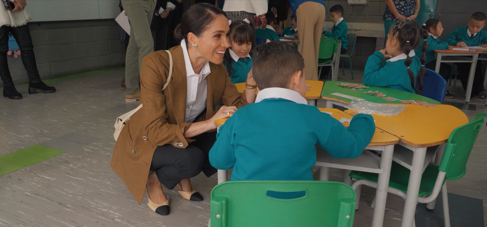 The Duchess of Sussex speaking to a pupil