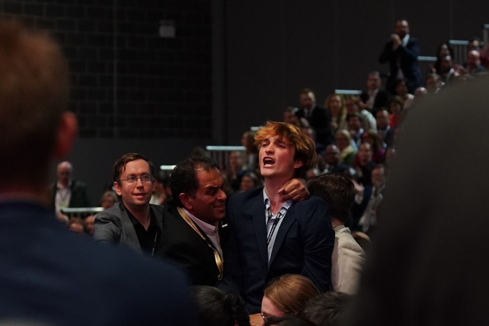 The lone protester was quickly removed from the ACC