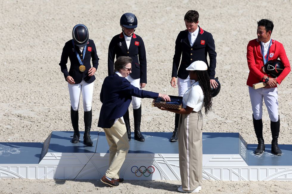 The Princess Royal hands over the gold medals to Rosalind Canter, Laura Collett and Tom McEwen