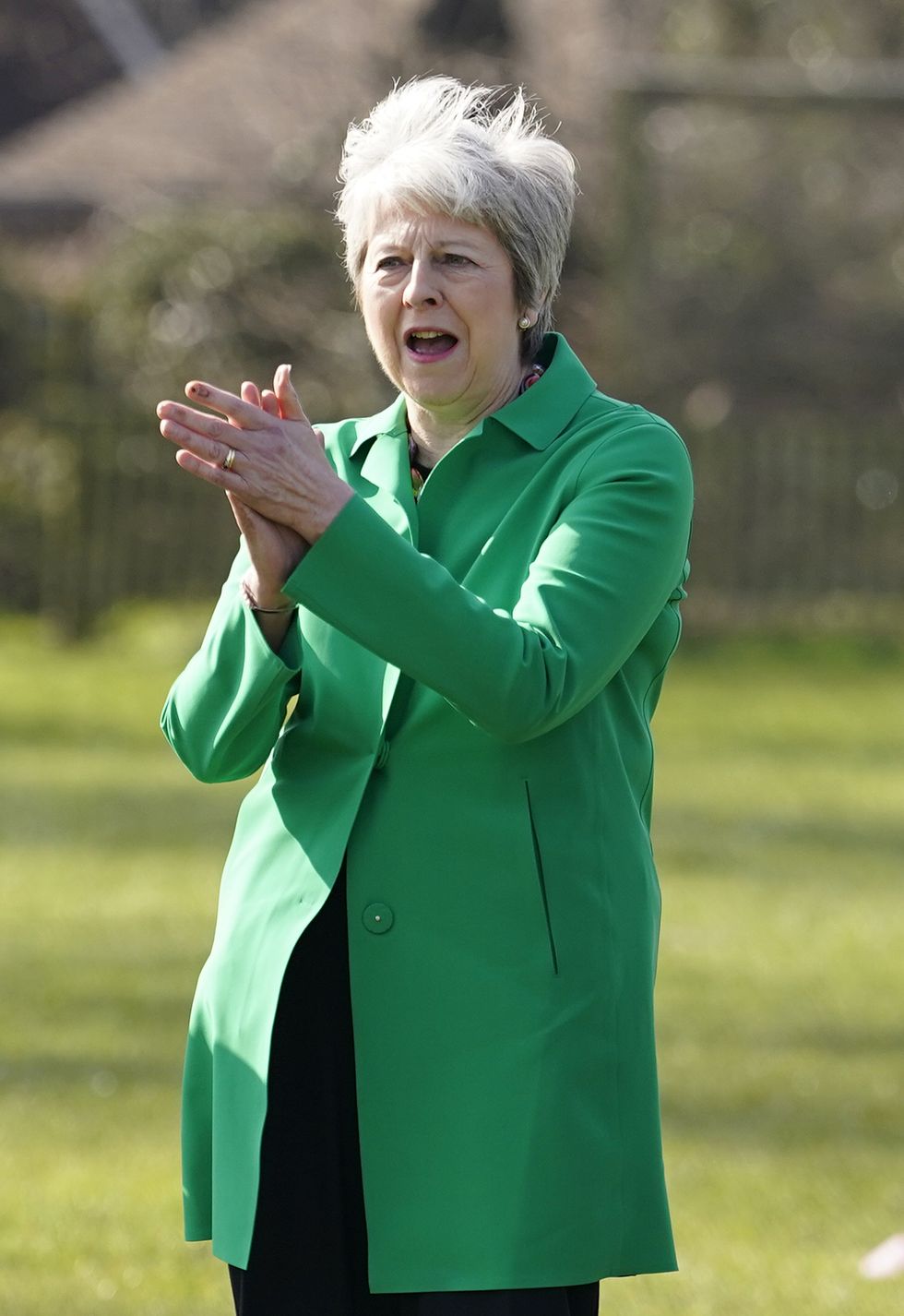 Theresa May clapping