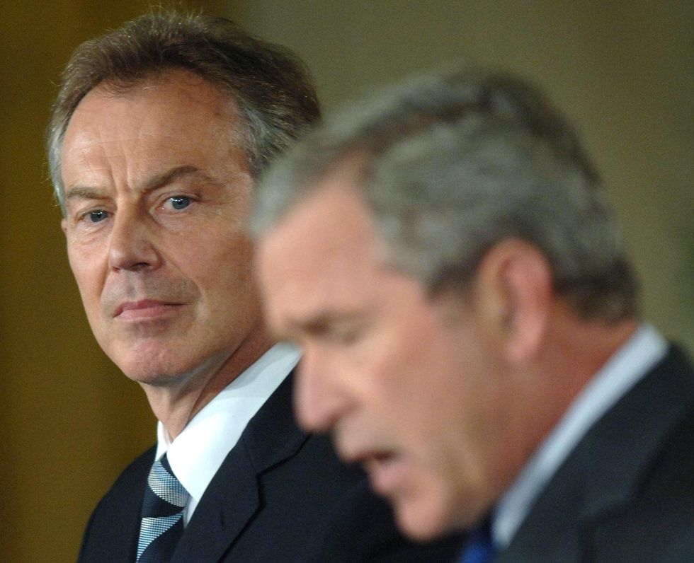 Tony Blair looks at George W. Bush