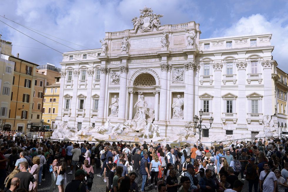 Tourists gather round Trevi Fountain