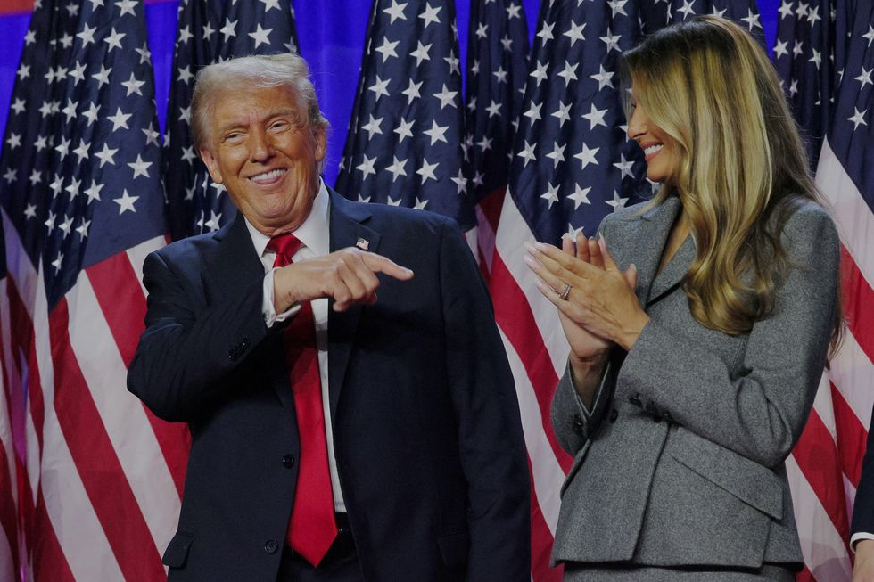 Trump next to his wife Melania at Trump HQ on Election Night