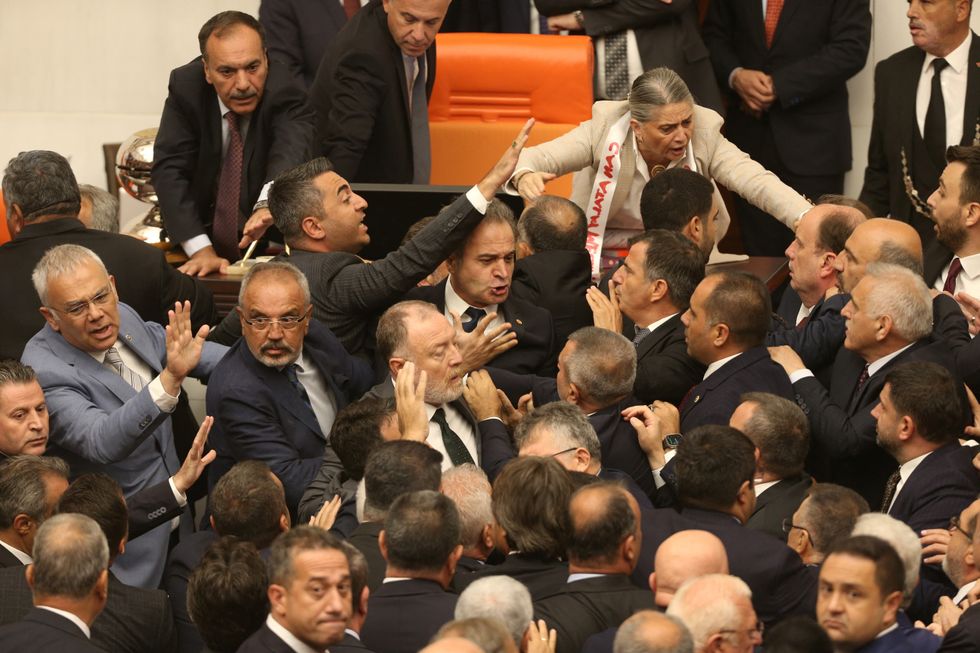 Turkey's ruling AK Party (AKP) lawmakers and opposition lawmakers argue during an extraordinary meeting of the Turkish parliament