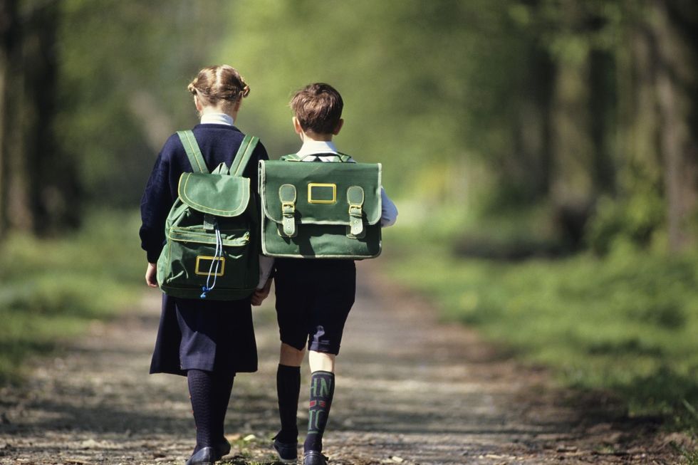 Two children in school uniform walking