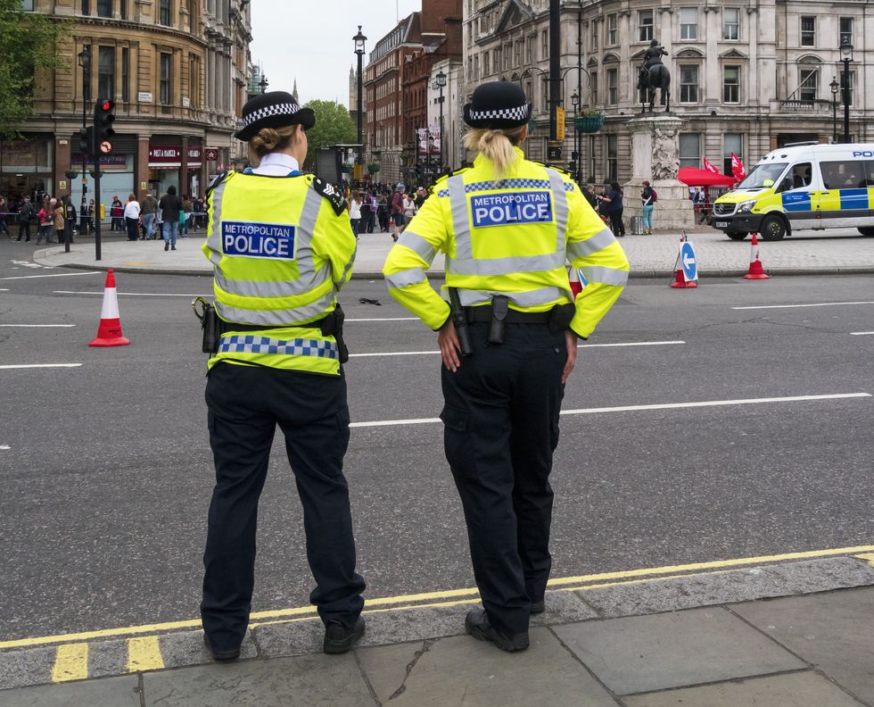 Two female Metropolitan Police officers standing roadside in Trafalgar Square