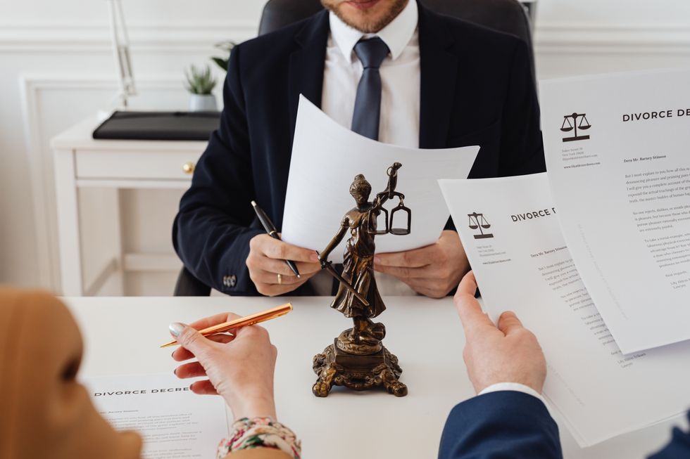 Two people signing divorce papers