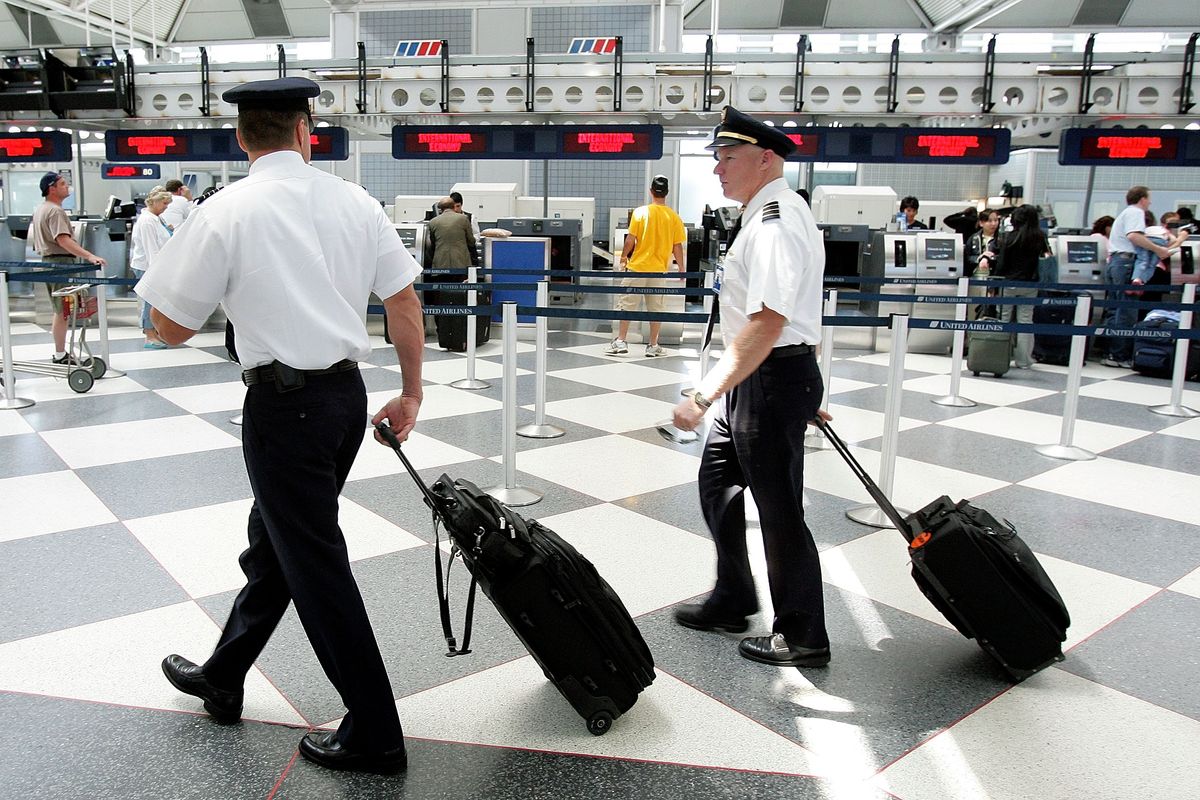 Two pilots walk through the United Airlines terminal at O'Hare International Airport May 31, 2005 in Chicago, Illinois