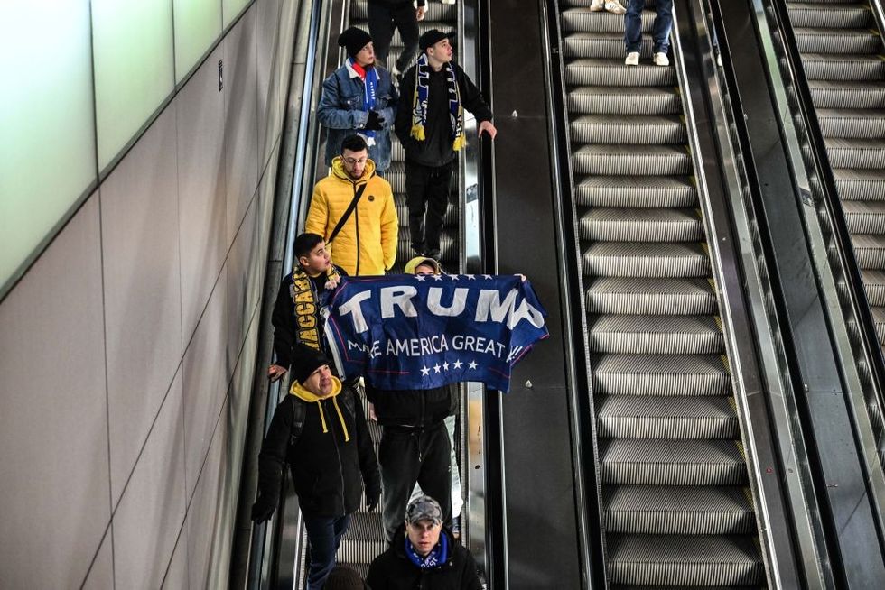 u200b: A fan opens a Trump banner as fans of Maccabi Tel Aviv stage a pro-Israel demonstration at the Dam Square,