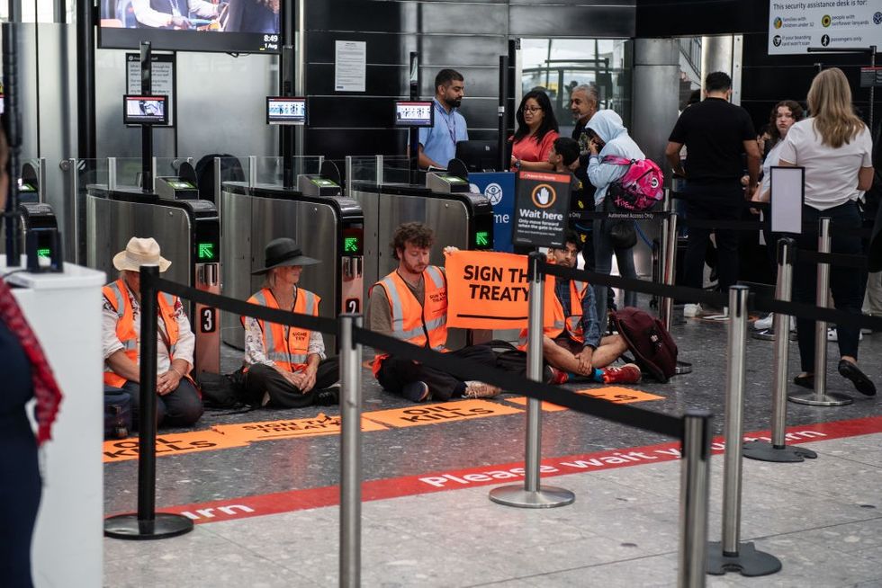 \u200b Just Stop Oil protestors block the departure gates at Heathrow Terminal 5