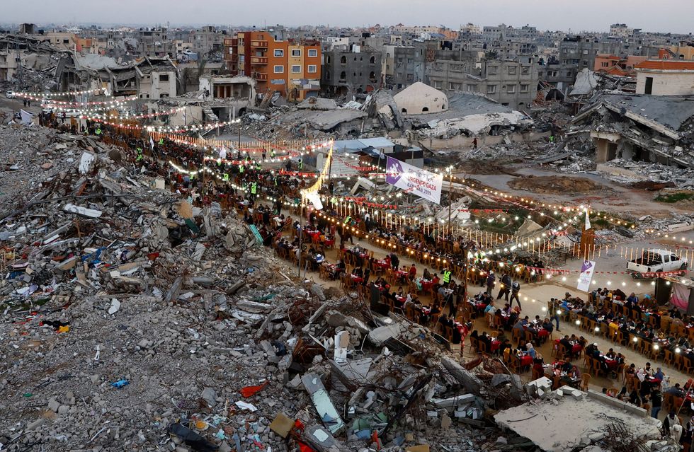 \u200b Palestinians break their fast by eating the Iftar meals during Ramadan