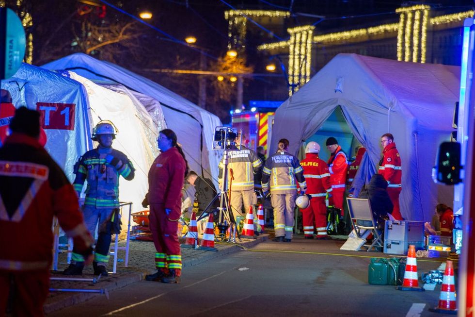 u200b Police vans and ambulances stand next to the annual Christmas market in the city centre