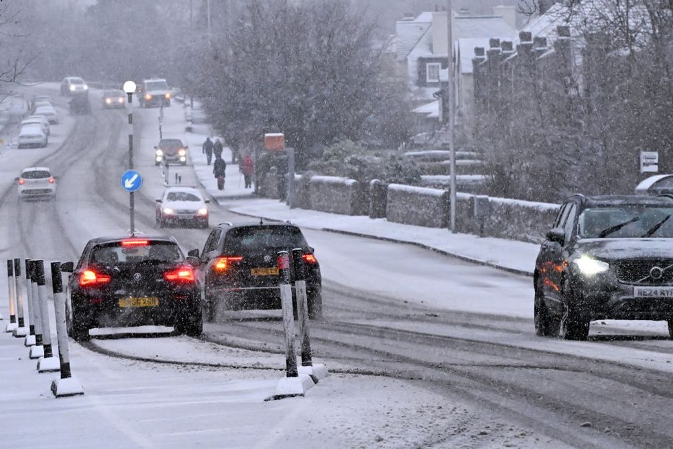 \u200b Traffic drives through falling snow on Lanark Road in Edinburgh