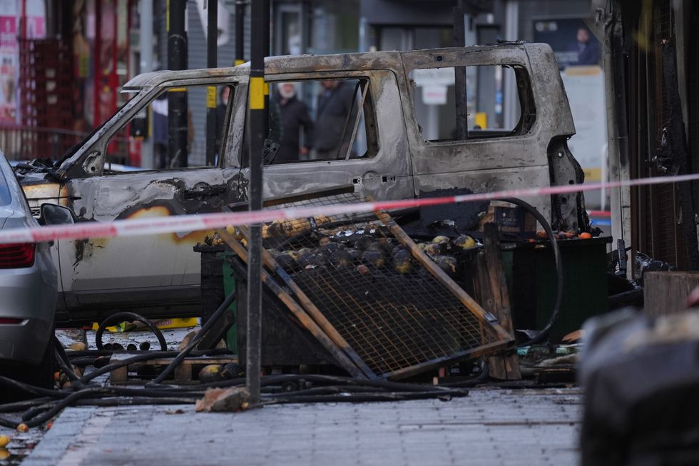 u200bA burnt out car at the scene of a fire at a mixed commercial and residential premises on Stratford Road in Sparkhill