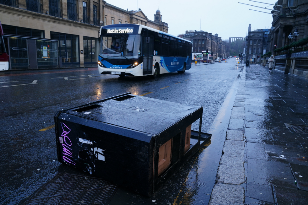 u200bA bus drives around bins blown over by the winds from Storm Eowyn on Princes Street, Edinburgh