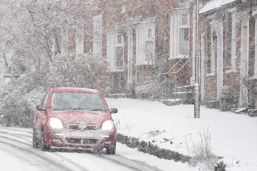 u200bA car driving through a snow flurry in Lenham, Kent.