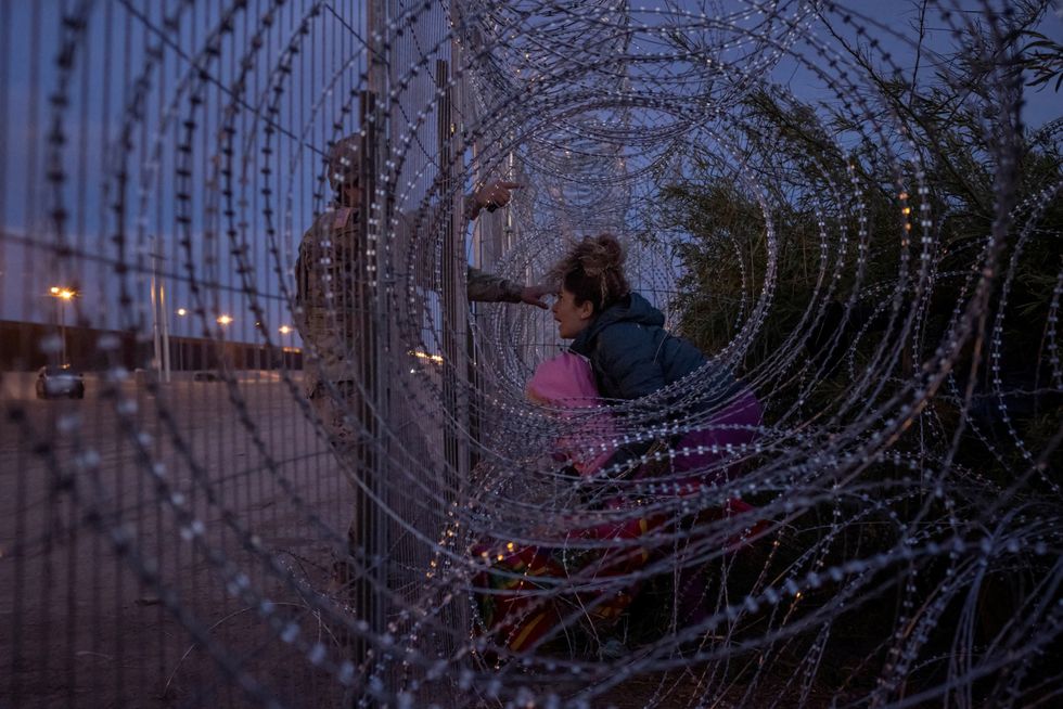 \u200bA migrant at the US-Mexico border