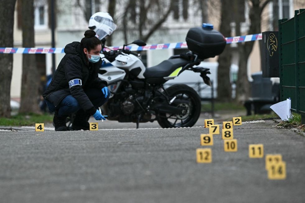 \u200bA police investigator of the French forensic police works to collect evidence at the site of the attack