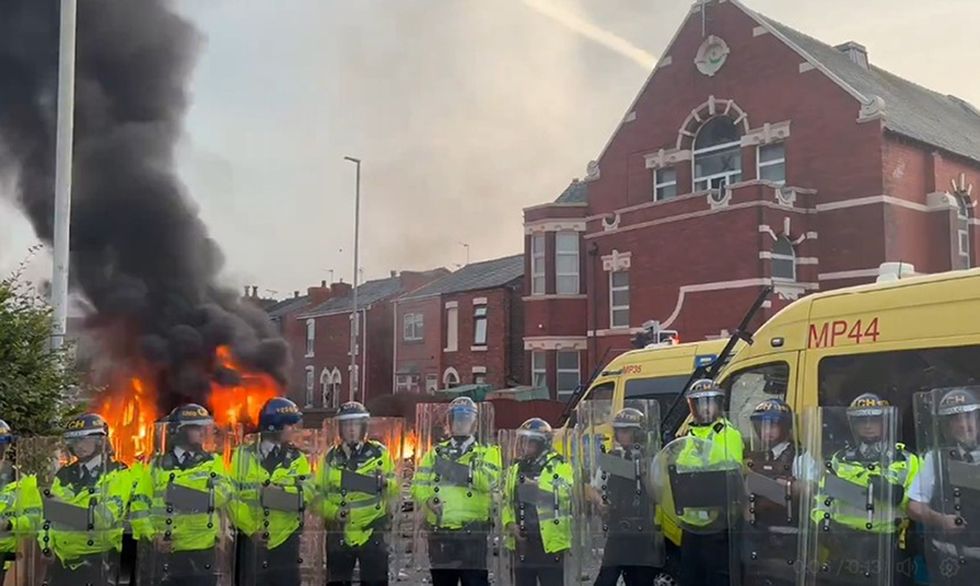 u200bA police van set alight as trouble flares in Southport