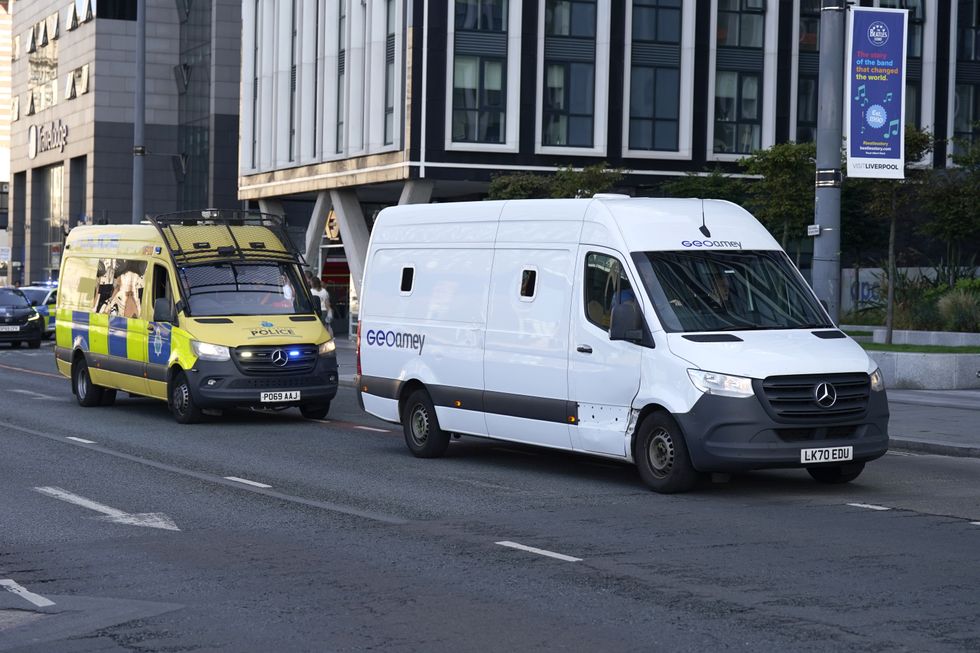 u200bA prison van escorted by multiple police vehicles arrives at Liverpool Magistrates' Court