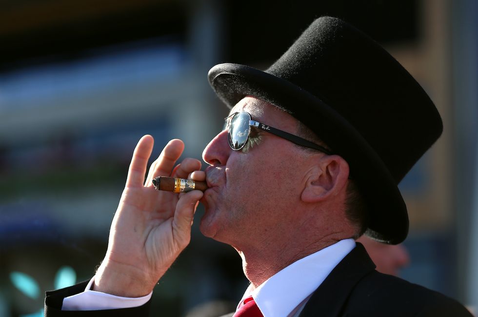 \u200bA punter smokes a cigar at Royal Ascot