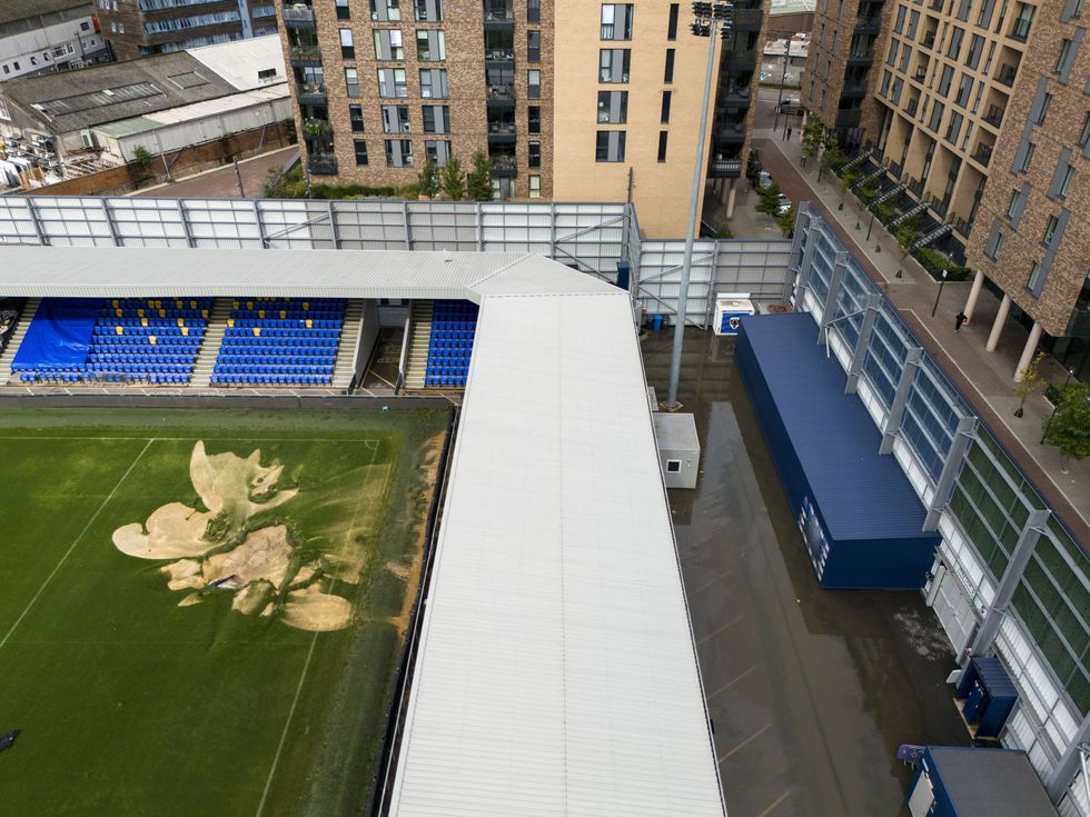 u200bA sinkhole on the pitch and flooded walkways at the Cherry Red Records Stadium, home of AFC Wimbledon