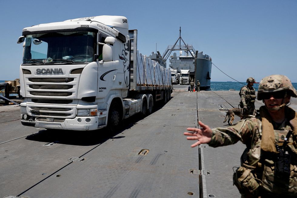 \u200bA truck carries humanitarian aid across Trident Pier