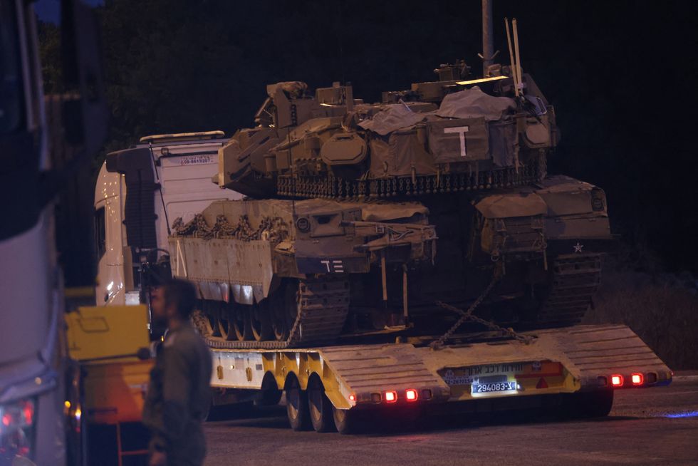 \u200bAn Israeli Army tank is transported, amid cross-border hostilities between Hezbollah and Israel