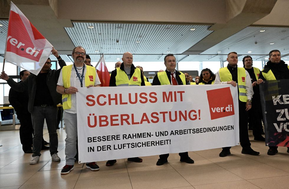 u200bAviation security workers of Germany's Verdi union gather at Cologne-Bonn airport - The placard reads 'end pressure of work'