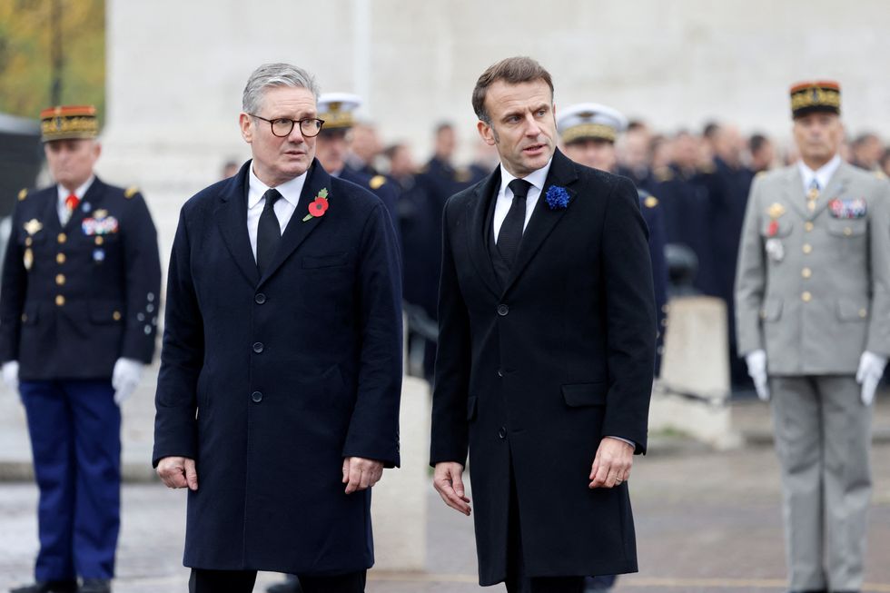 \u200bBritain's Prime Minister Keir Starmer and France's President Emmanuel Macron watch as the French Republican Guard cavalry (Garde Republicaine) parades on the Place de l'Etoile