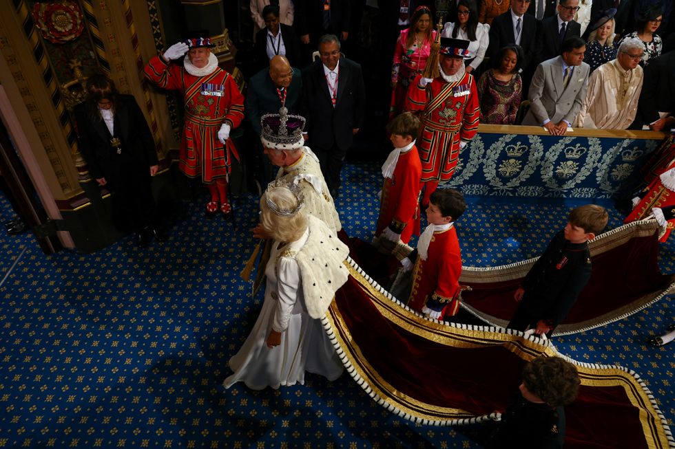 u200bCharles, Camilla and the page boys walk up to the throne