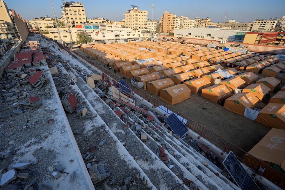 \u200bDisplaced Palestinians take shelter in a tent camp set up at Palestine Stadium