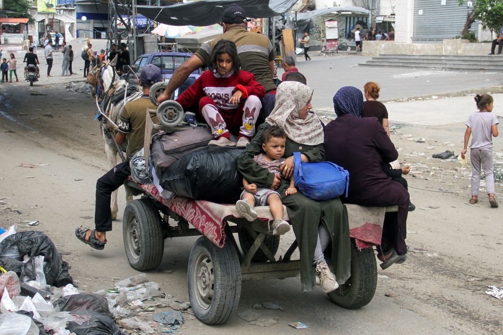 \u200bDisplaced Palestinians travel in an animal-drawn cart as they flee areas in the northern Gaza Strip